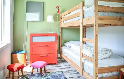 a bedroom with a bunk bed and a red dresser at Amazing Home In Etne With Wifi in Erve