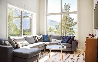a living room with a couch and a table at Amazing Home In Etne With Wifi in Erve