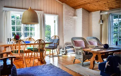a dining room with a table and chairs at Gorgeous Home In Reksteren With Kitchen in Klinkholmen