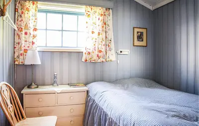 a bedroom with a bed and a dresser and a window at Gorgeous Home In Reksteren With Kitchen in Klinkholmen