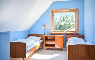 a room with two beds and a window at Lovely Home In Fjelberg With Wifi in Sæbø