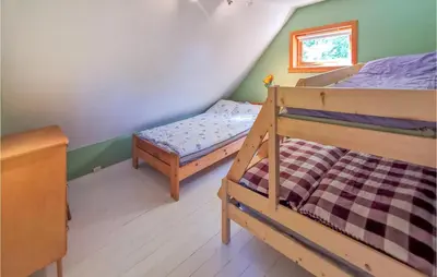 a bedroom with two bunk beds and a window at Lovely Home In Fjelberg With Wifi in Sæbø