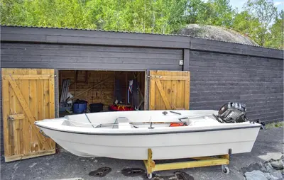 a boat parked in front of a building at Beautiful Home In Jondal in Jondal