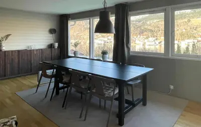 a dining room table with chairs and a large window at Cozy Home In Ulvik With Wifi in Ulvik