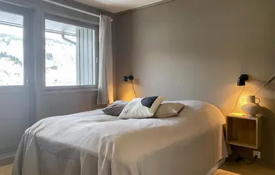 a bedroom with a white bed with a window at Cozy Home In Ulvik With Wifi in Ulvik
