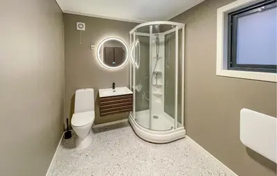 a bathroom with a shower and a toilet and a sink at Cozy Home In Ulvik With Wifi in Ulvik