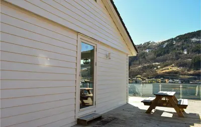 a side of a building with a picnic table next to it at 3 Bedroom Amazing Home In Norheimsund in Norheimsund