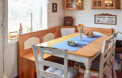 a dining room with a wooden table and chairs at Amazing Home In Fonnes With Wifi in Fonnes