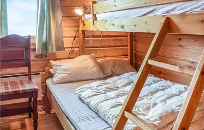 a bedroom with two bunk beds in a cabin at 3 Bedroom Amazing Home In Vossestrand in Vossestrand