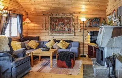 a living room with a couch and a fireplace at 3 Bedroom Amazing Home In Vossestrand in Vossestrand