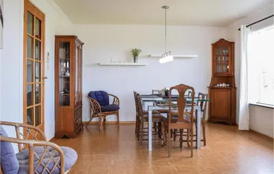 a dining room with a table and chairs at Amazing Home In Torangsvåg With Wifi in Skår