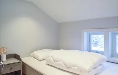 a white bedroom with a white bed and a window at Lovely Home In Masfjordnes With Wifi in Masfjorden