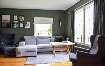 a living room with a couch and a table at Beach Front Home In Tysse With Wifi in Tysse