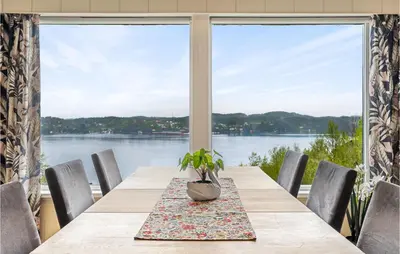 a table with a potted plant on it in front of a window at 2 Bedroom Nice Home In Fana in Fanahammaren