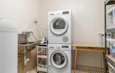 a washer and dryer in a kitchen with a sink at 2 Bedroom Nice Home In Fana in Fanahammaren