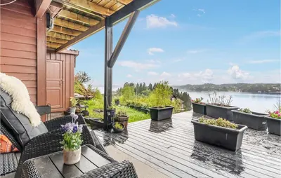 a deck with a view of the water at 2 Bedroom Nice Home In Fana in Fanahammaren