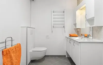 a white bathroom with a toilet and a sink at 2 Bedroom Nice Home In Fana in Fanahammaren