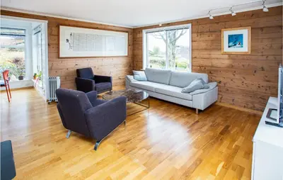 a living room with a couch and two chairs at Cozy Home In Bruvik With Wifi in Bruvik