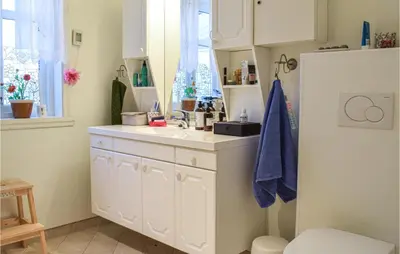 a kitchen with white cabinets and a sink at Gorgeous Home In Fjell With Wifi in Lokøy