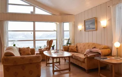 a living room with a couch and a table at 5 Bedroom Beach Front Home In Lavik in Lavik