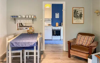 a small kitchen with a table and a chair at Nice Home In Byrkjelo With Kitchen in Byrkjelobrua