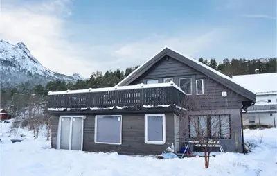 a wooden house with a balcony on top in the snow at 3 Bedroom Beautiful Home In Eikefjord in Eikefjord