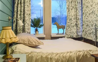 a bedroom with a bed with a deer in a window at 3 Bedroom Beautiful Home In Eikefjord in Eikefjord