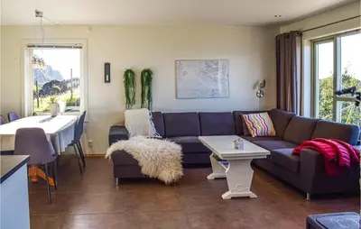 a living room with a couch and a table at Valvik in Tansøy
