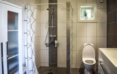 a bathroom with a toilet and a shower at Valvik in Tansøy