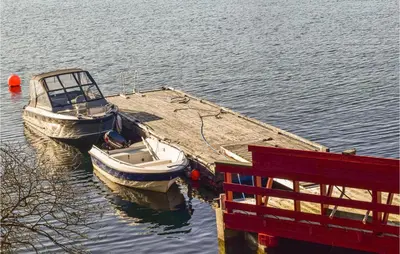 two boats are docked at a dock in the water at Valvik in Tansøy