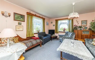 a living room with a couch and a table at Awesome Home In Oldedalen in Briksdalsbre