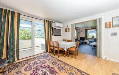 a dining room with a table and a window at Awesome Home In Oldedalen in Briksdalsbre