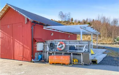 a red barn with a red roof at Lovely Apartment In Ellingsøy in Myklebost