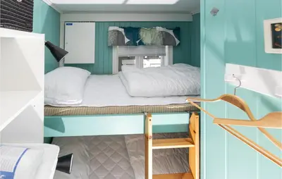 a bunk bed in a small room with blue walls at 2 Bedroom Awesome Home In Isfjorden in Isfjorden