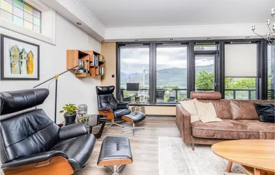 a living room with a couch and chairs at Gorgeous Home In Vestnes With Wifi in Vestnes
