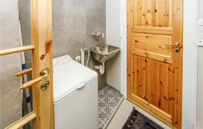a small bathroom with a sink and a washing machine at 2 Bedroom Stunning Apartment In Åfarnes in Åfarnes