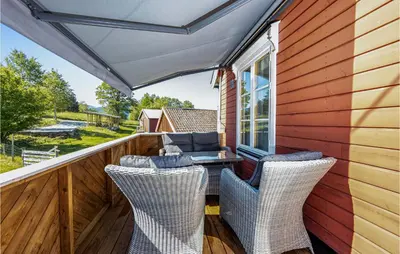 a patio with a table and chairs on a deck at 2 Bedroom Stunning Apartment In Åfarnes in Åfarnes