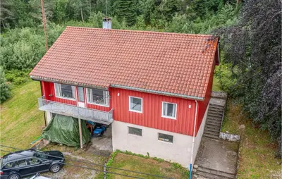 a red house with a car parked in front of it at 5 Bedroom Pet Friendly Home In Vestnes in Vestnes