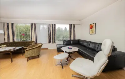 a living room with a black leather couch and chairs at 5 Bedroom Pet Friendly Home In Vestnes in Vestnes