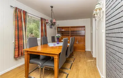 a dining room with a wooden table and chairs at 5 Bedroom Pet Friendly Home In Vestnes in Vestnes