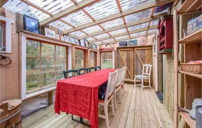a room with a table and chairs and a glass ceiling at 2 Bedroom Cozy Home In Øydegard in Nastad