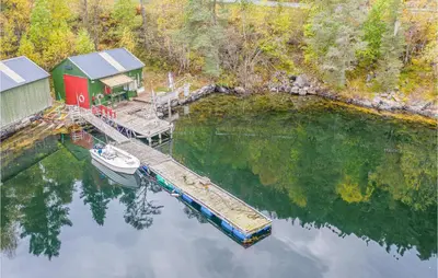 an aerial view of a house and a boat on the water at 2 Bedroom Cozy Home In Øydegard in Nastad