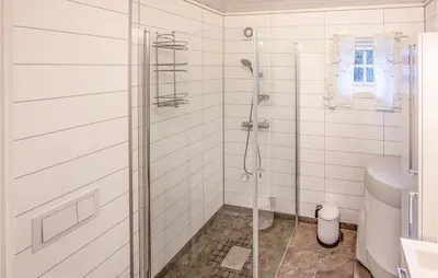 a white bathroom with a shower and a toilet at 2 Bedroom Cozy Home In Øydegard in Nastad
