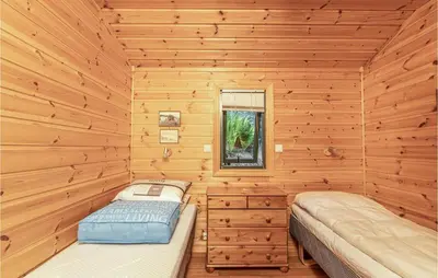 a log cabin with two beds in it at 3 Bedroom Beautiful Home In Øydegard in Aspa