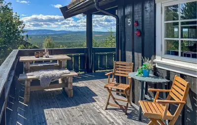 a deck with a table and chairs on a house at Pet Friendly Home In Rena With Wifi in Rena