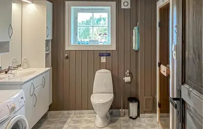 a bathroom with a toilet and a sink and a window at Pet Friendly Home In Rena With Wifi in Rena