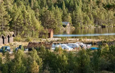 a group of cars parked next to a body of water at 3 Bedroom Lovely Home In Tynset in Tynset