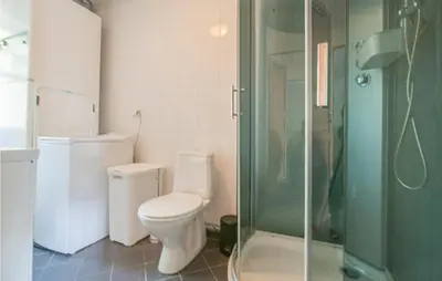 a bathroom with a toilet and a glass shower at Gorgeous Home In Søre Osen With Wifi in Midskogberget