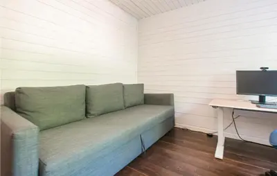 a couch in a room with a desk and a computer at Gorgeous Home In Søre Osen With Wifi in Midskogberget