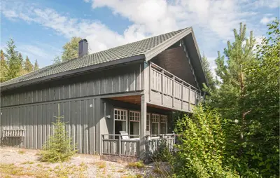 a gray barn with a gambrel roof at Gorgeous Home In Søre Osen With Wifi in Midskogberget